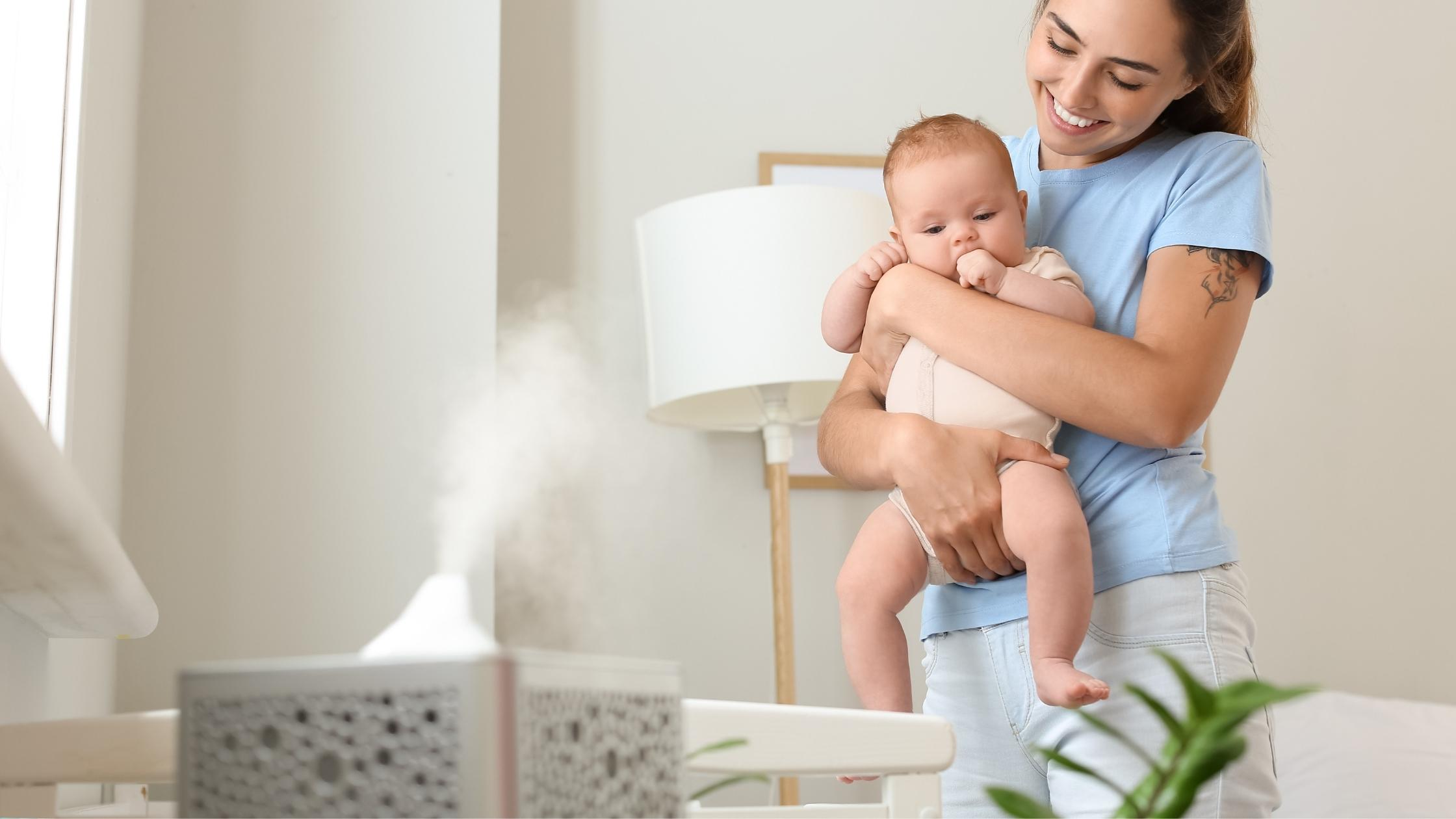 women holding her baby next to humidifier